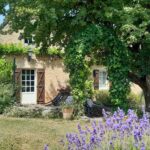 a picture looking at a stone house with shutters