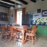a picture of a kitchen with dining table and chairs