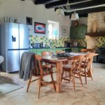 a picture of a kitchen with dining table and chairs