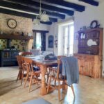 a picture of a kitchen with dining table and chairs